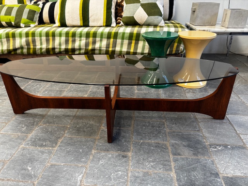 Table basse ovale structure palissandre dessus verre fumé de Hugues Poignant 144x54xH36cm